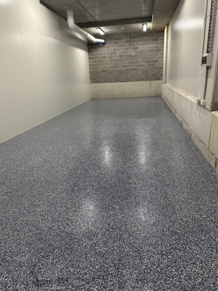 Grey industrial flake epoxy floor in a storage room