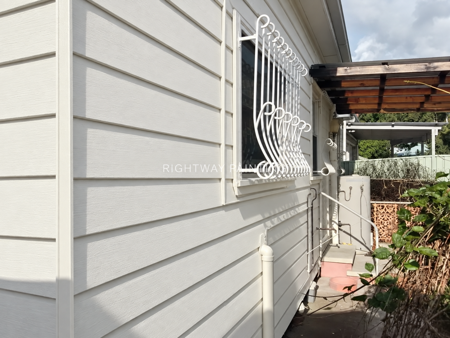 Completed Surfmist weatherboards and white window cage